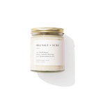 Candle jar labeled 'Sea Salt + Surf' on a white background