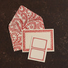 Red and white patterned cards on a dark brown surface