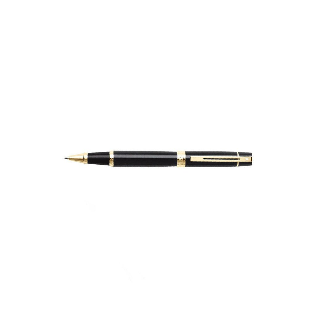 Black and gold pen on a white background