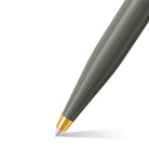 Gray pen with a gold cap on a white background