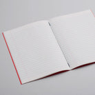 Open lined notebook on light background