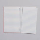 Lined notebook with page torn out on light background
