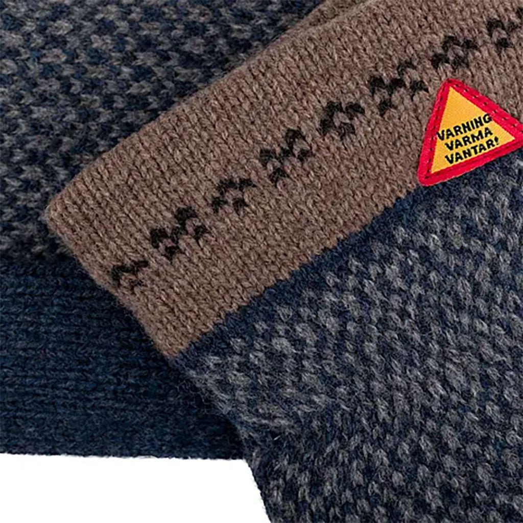 Textile product with a brown strip and warning label on a textured surface