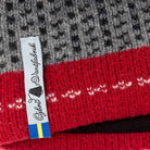 Close-up of a red and gray knitted fabric with a visible label.