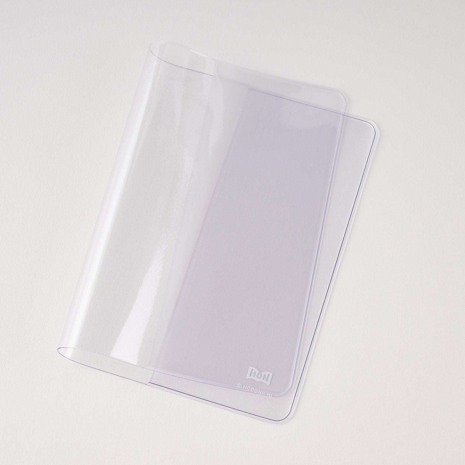 Clear PVC cover for A6 Hobonichi HON book on white background