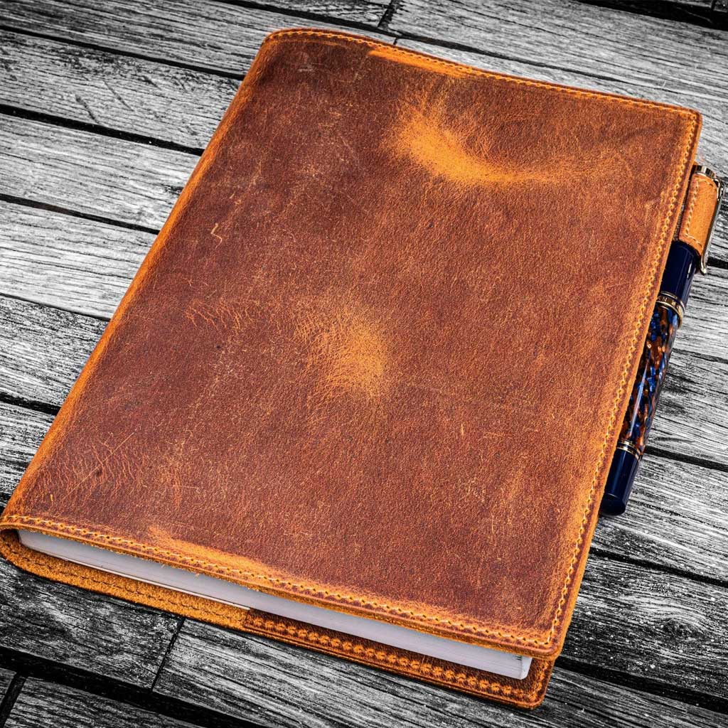 Brown leather notebook on a wooden surface