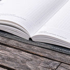 Planner in gray notebook cover on wooden surface