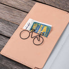 Natural undyed leather notebook cover with paper clip on wooden surface