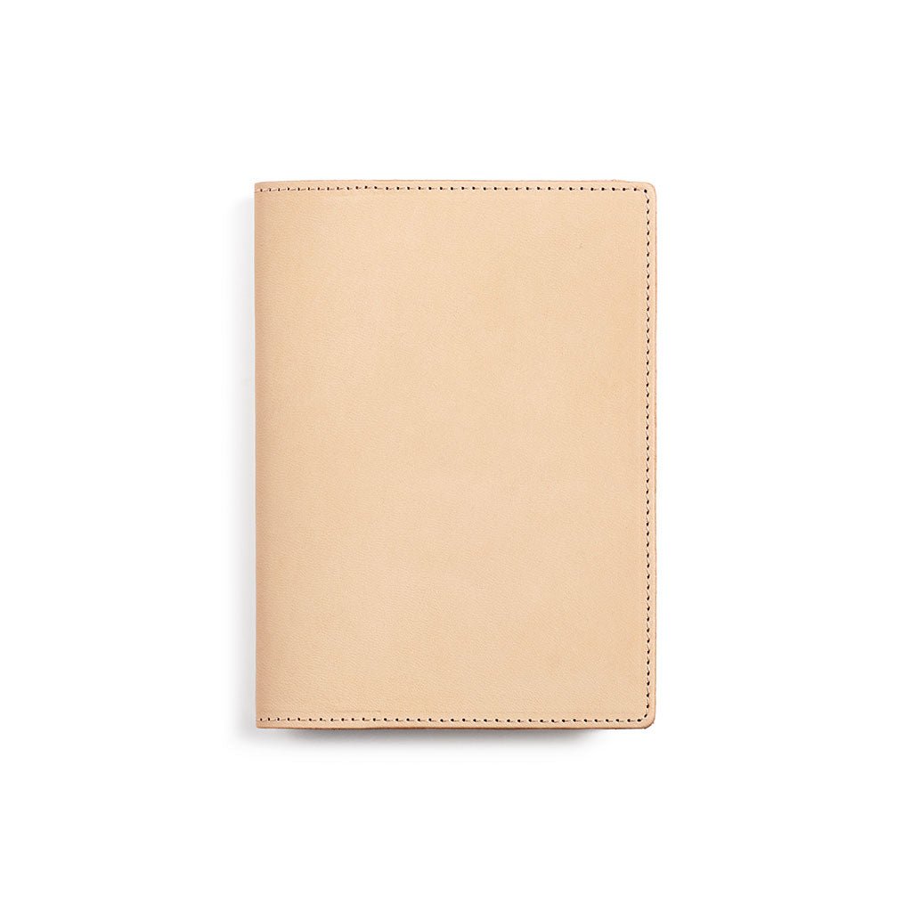 Natural undyed leather A6 notebook cover on white background