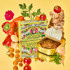 Packaging of tinned Fishwife Smoked Trout with Red Chimichurri on colorful background next to produce and bread