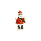 A small Santa Claus incense burner standing on a white base, wearing a red coat and hat with white trim, a dark green scarf, black boots, and holding a small tree and staff, photographed on a plain white background.