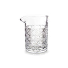Clear mixing glass with geometric pattern on white background