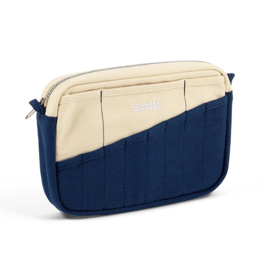 Side view of blue and beige canvas pouch on white background.