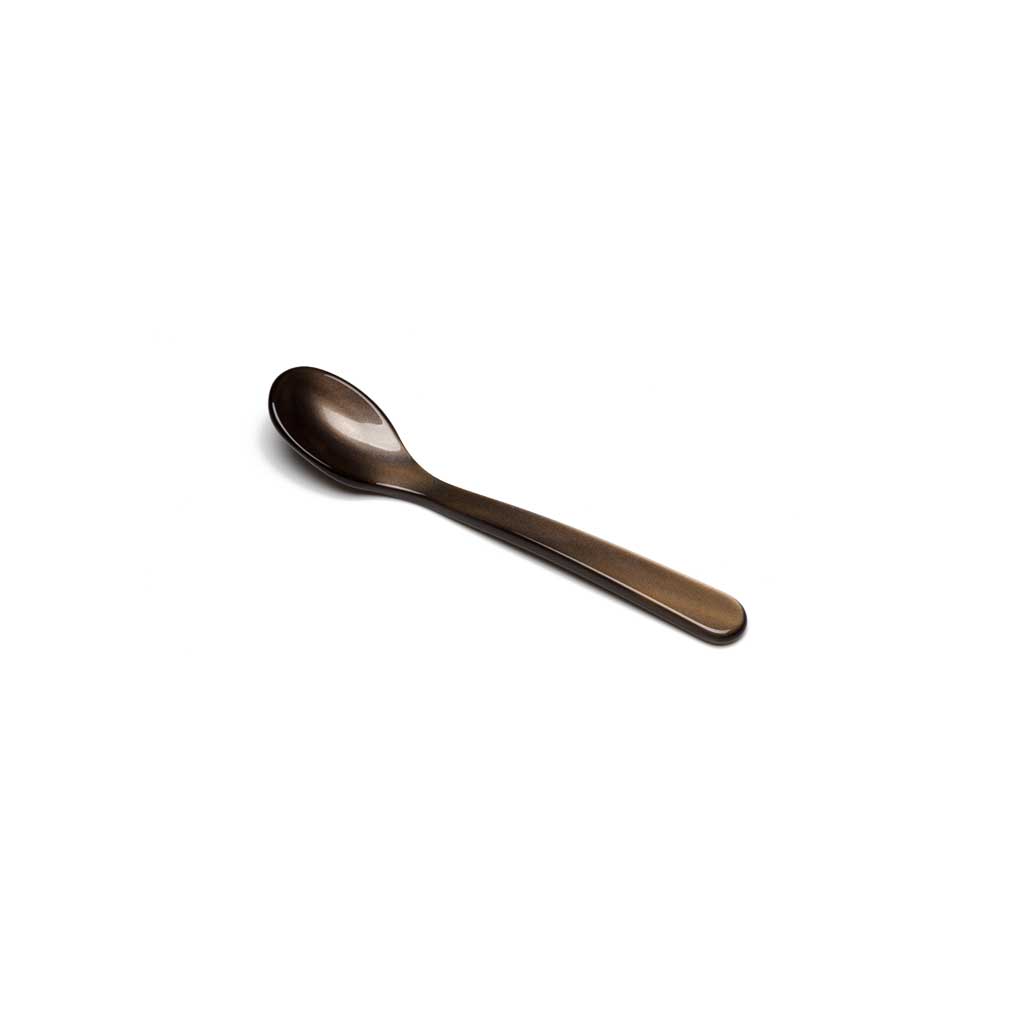 Brown acrylic salt spoon on white background