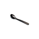 Brownish gray acrylic salt spoon on white background