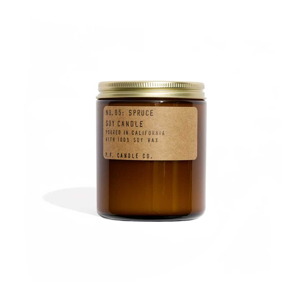 Brown candle with a gold lid and label on a white background