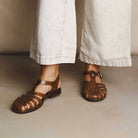 Model wearing hemp jelly sandals against light backdrop