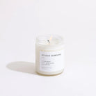 Lit candle labeled 'Sunday Morning' on a white background