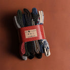 Pack of colorful socks with a red band on a brown background