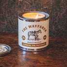 Candle in a can labeled 'The Wayfarer' by Bradley Mountain on a wooden surface.