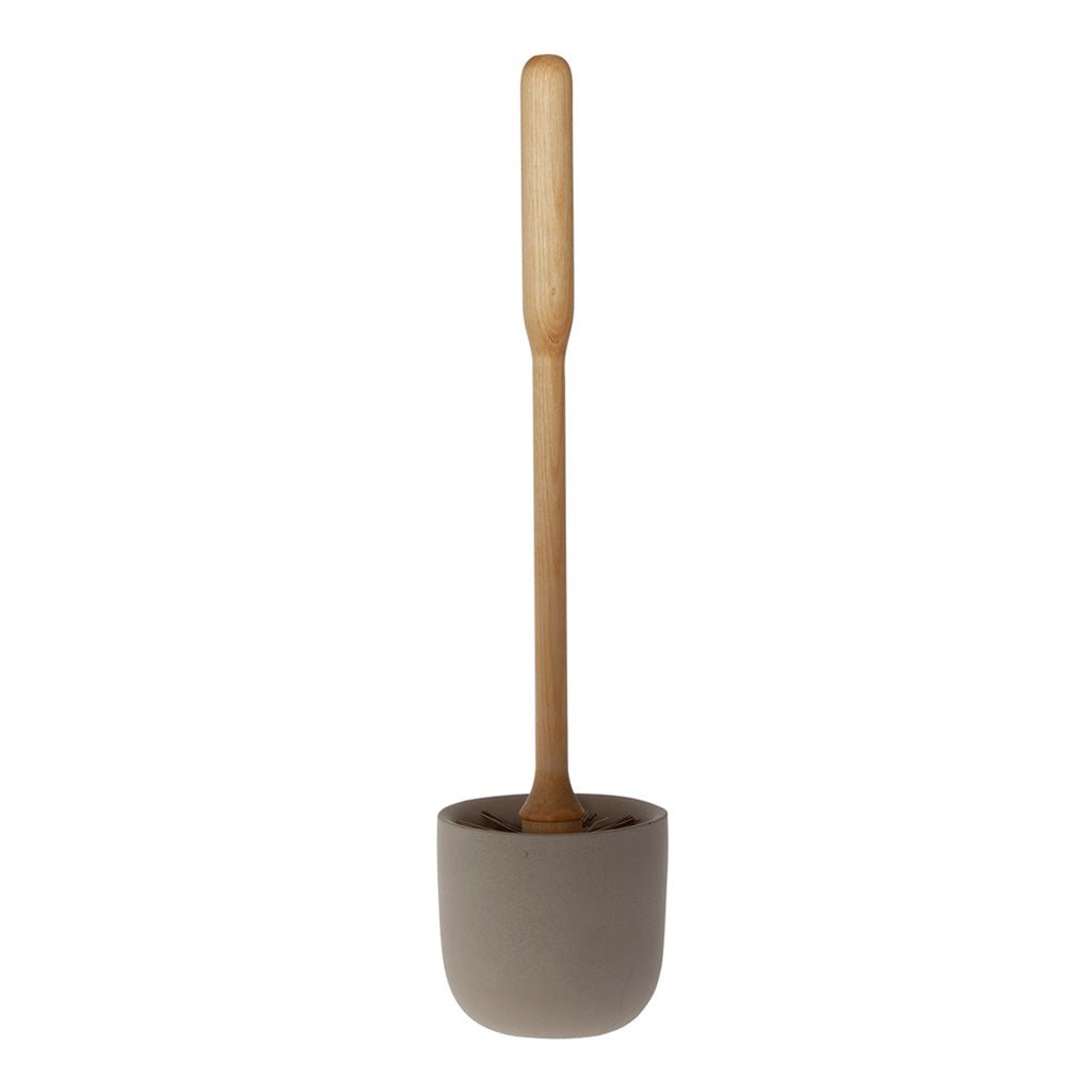 A concrete toilet brush holder with toilet brush on white background