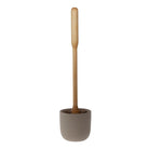 A concrete toilet brush holder with toilet brush on white background