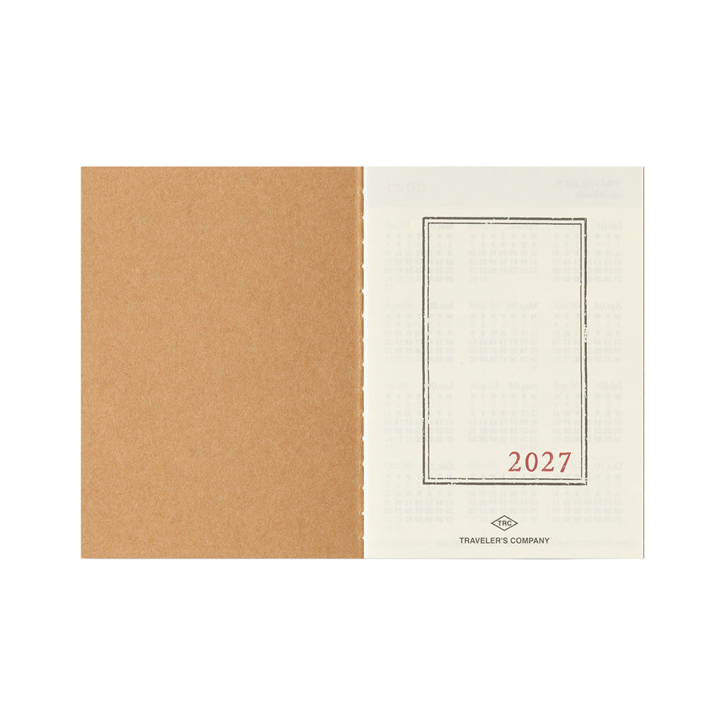 An open Traveler's Passport Notebook refill for 2027 on white background