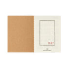 An open Traveler's Passport Notebook refill for 2027 on white background
