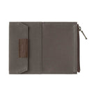 Brown card-size zippered case for traveler's notebook on white background