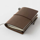 Brown Card-size notebook closed on light background