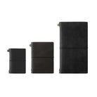 Three traveler's notebooks on white background to show scale. Card-size, then passport, then regular.