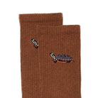 Brown socks with turtle design on a white background