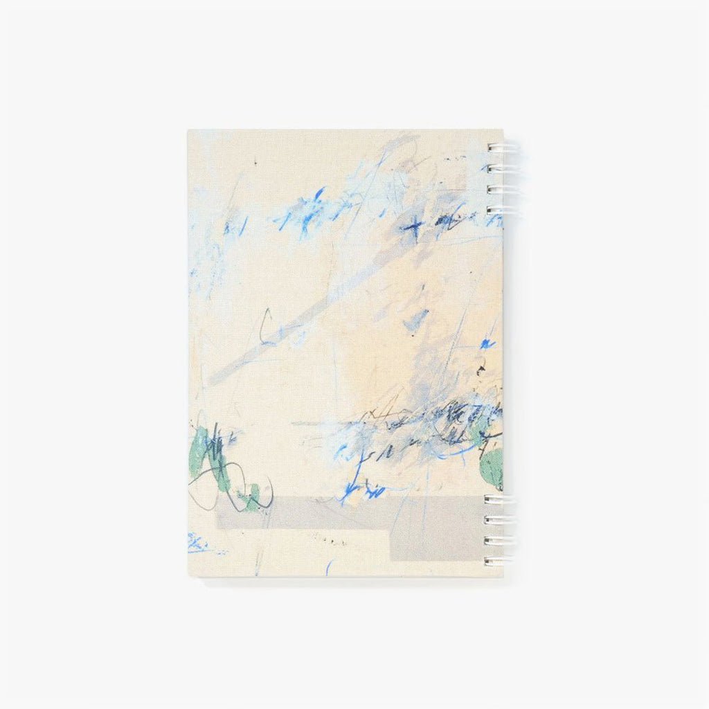 Notebook with abstract blue and green design on a beige background