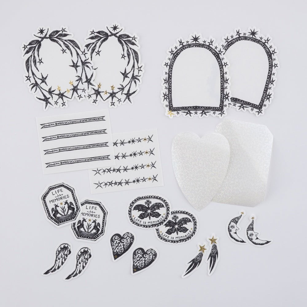 Collection of hand-drawn black and white Hobonichi not a dream stickers laying on white surface