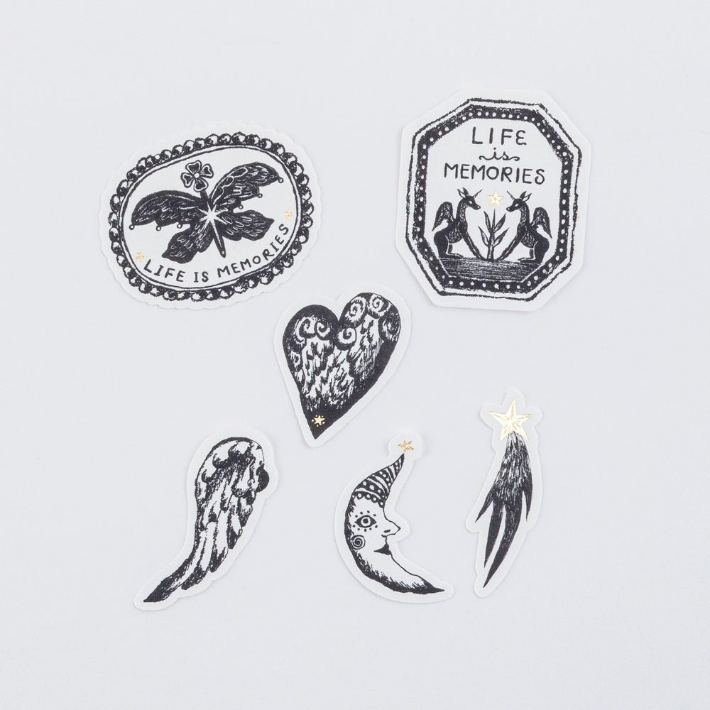 Set of black and white decorative stickers with various designs on a light gray background.