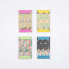 View of back of four Hobonichi Unsodo mini paper envelopes with traditional Japanese woodblock print designs on white background