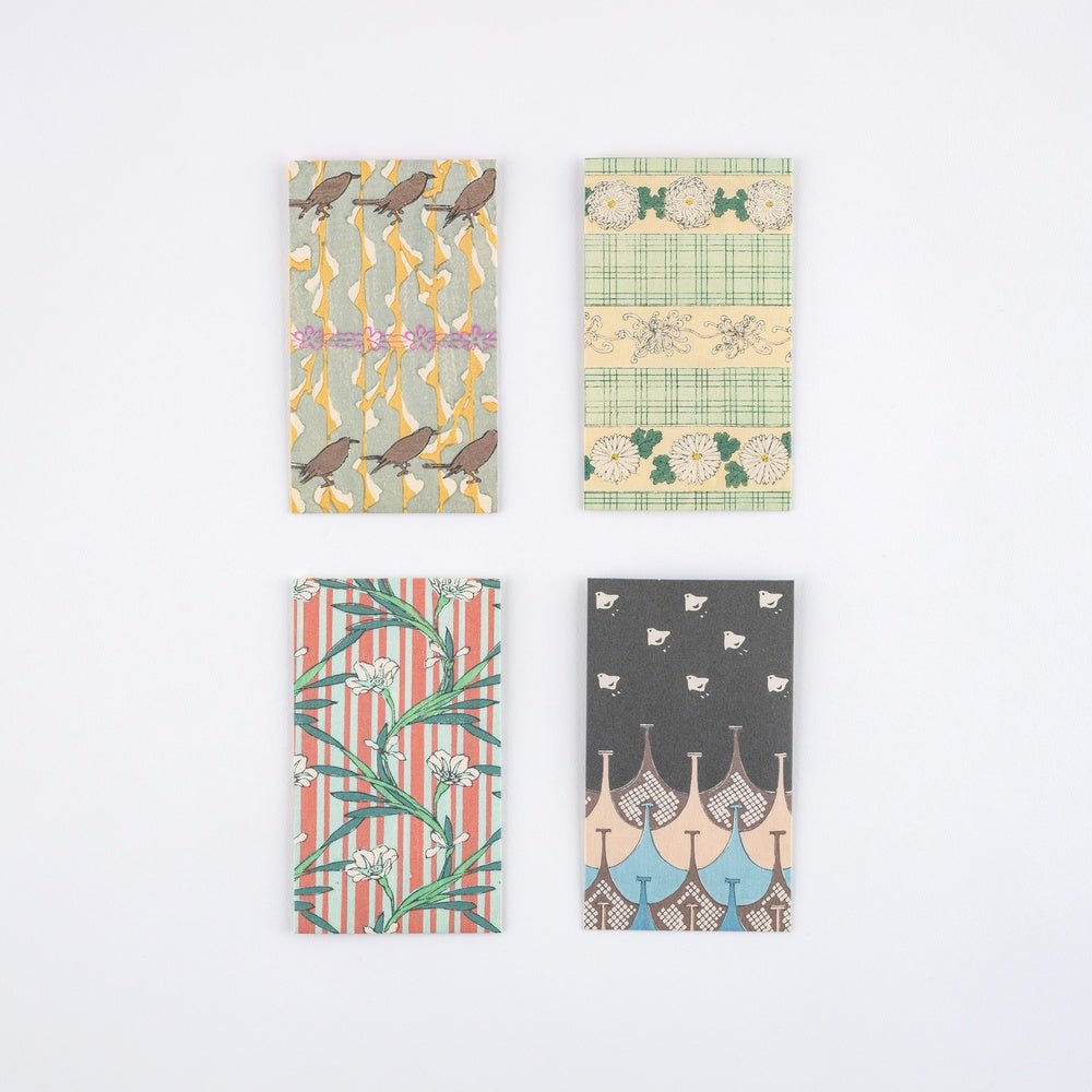 Set of four Hobonichi Unsodo mini paper envelopes with traditional Japanese woodblock print designs on white surface