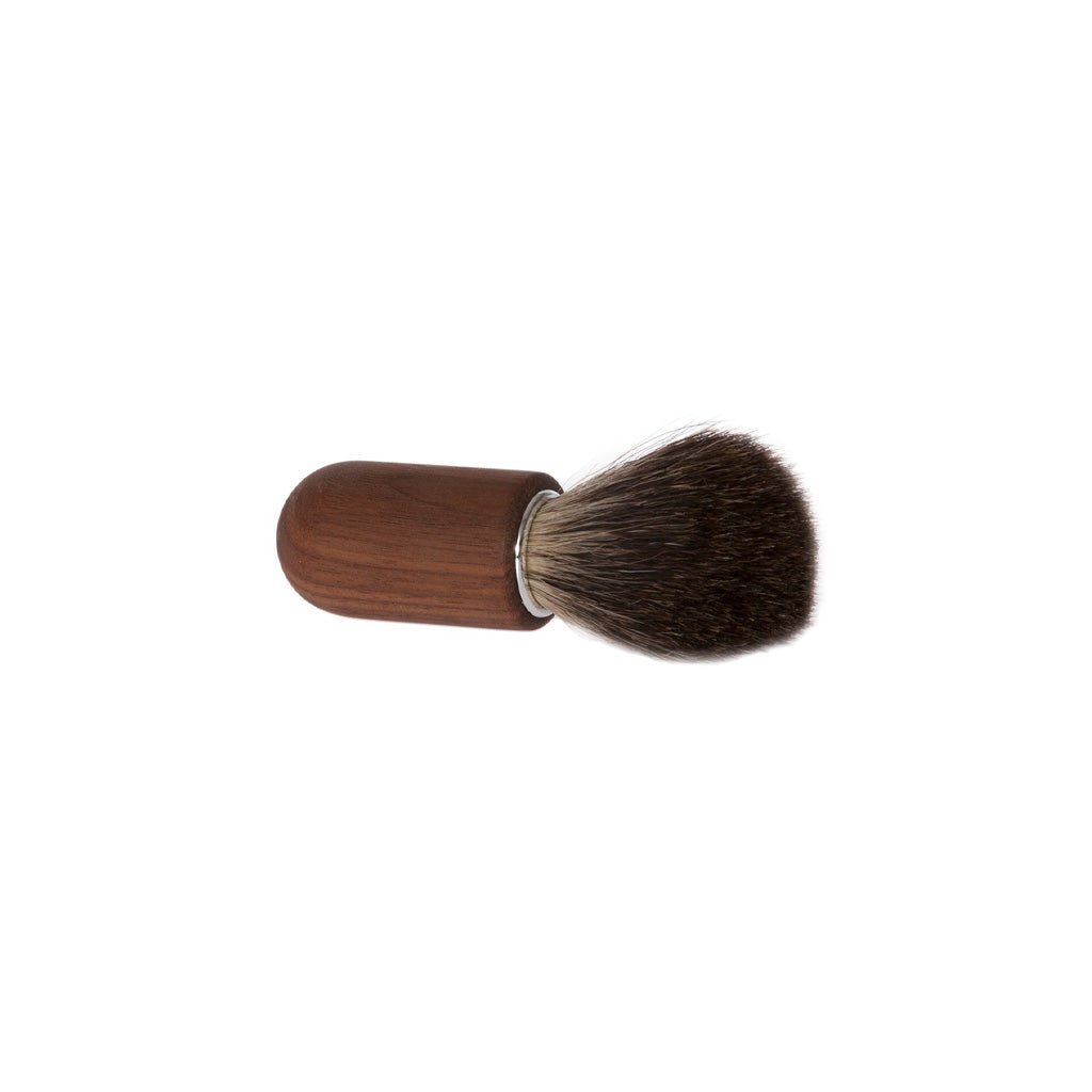 Small walnut wooden shaving brush with dakr badger hair bristles on white background