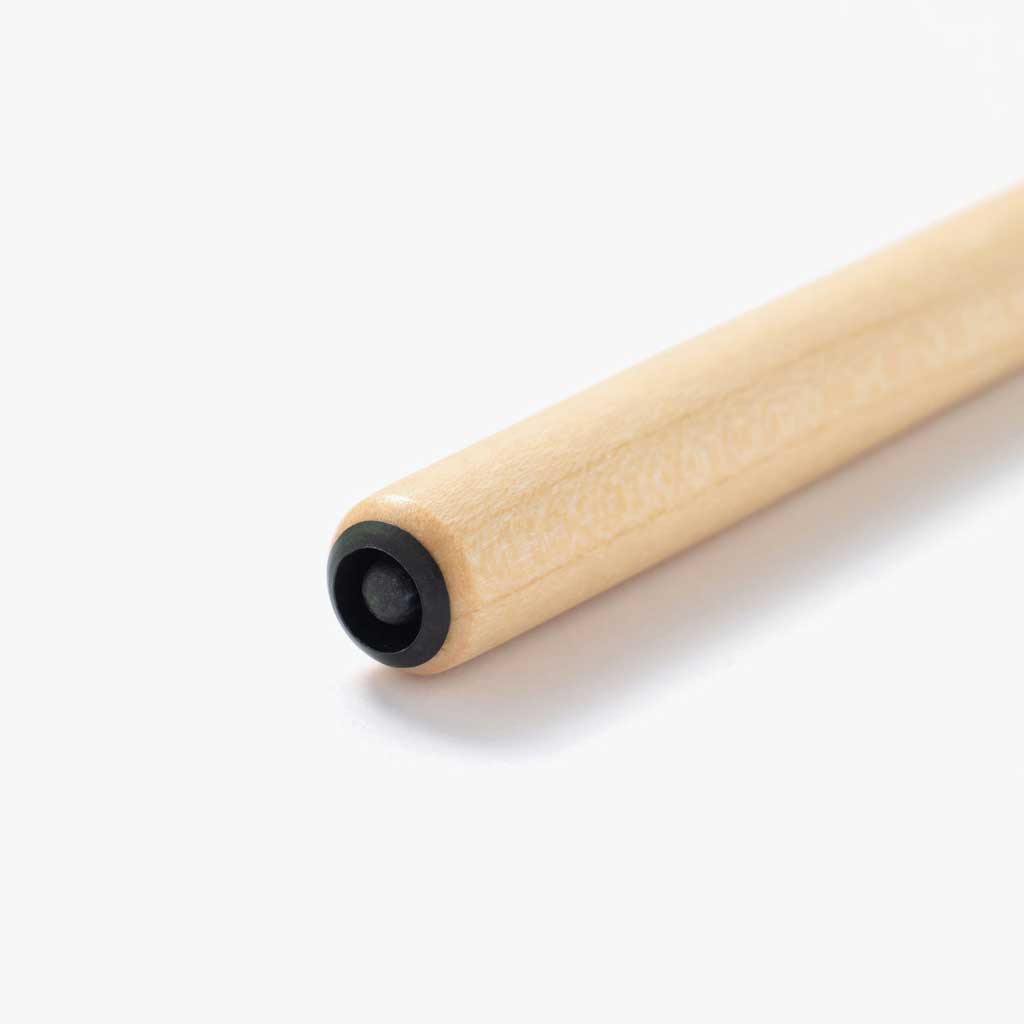 Nib mount of light white wooden nib holder on white surface