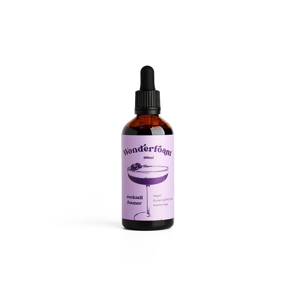 Bottle of wonderfoam cocktail foamer with purple label on white background