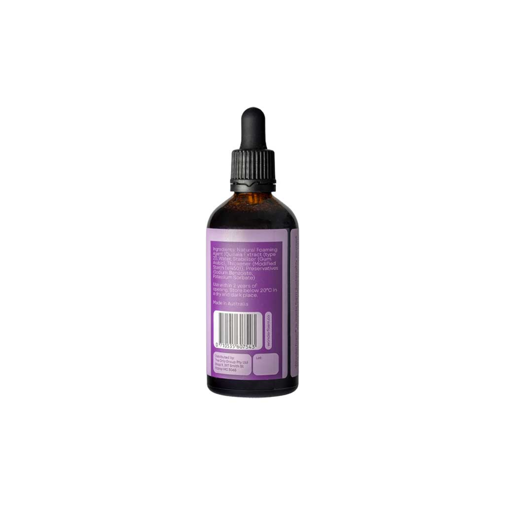 Bottle of wonderfoam cocktail foamer with purple label on white background