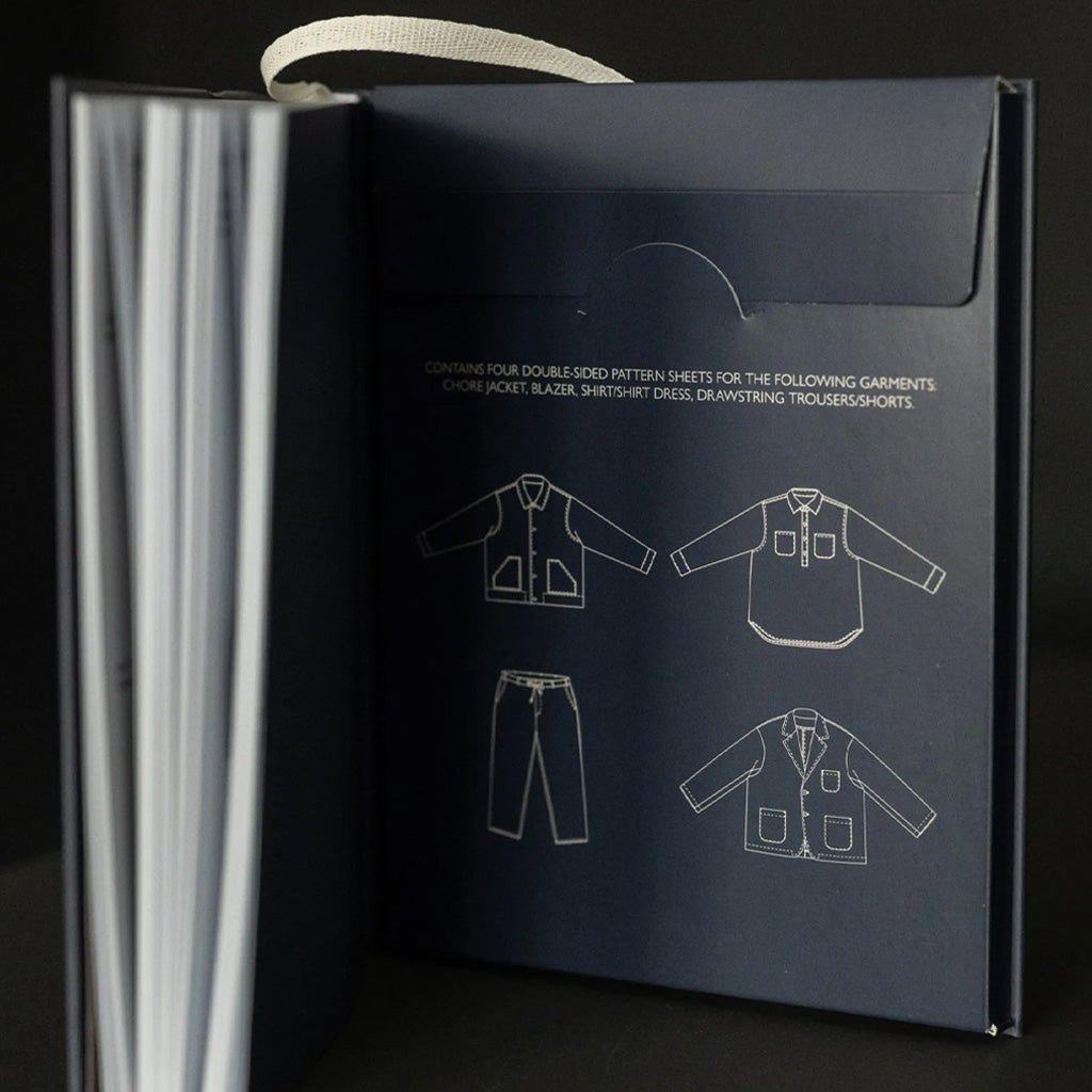 Dark blue sewing pattern sleeve with garment illustrations on a black background