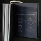 Dark blue sewing pattern sleeve with garment illustrations on a black background