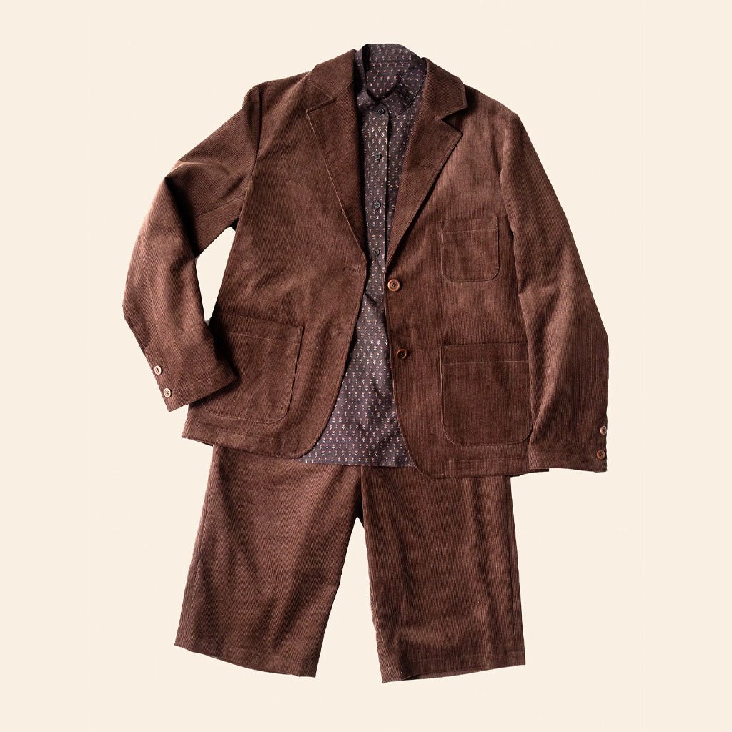 Brown suit jacket and pants on a beige background
