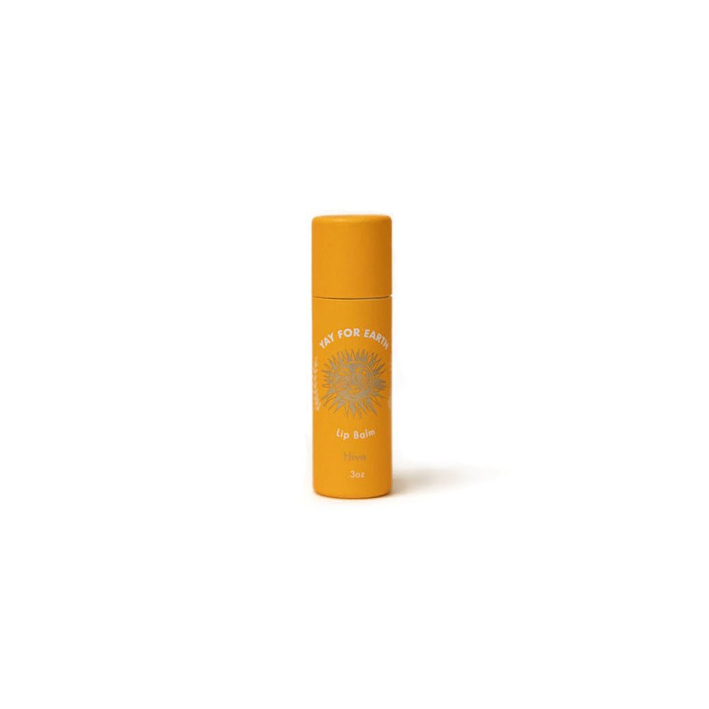 Orange Hive lip balm with a sun design on a white background