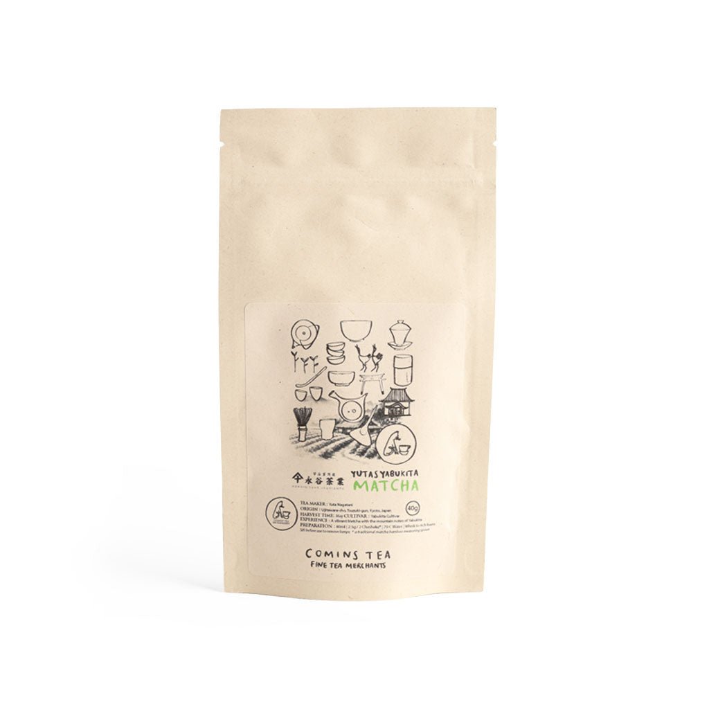 Kraft bag of Yuta's Yabukita matcha green tea by Comins tea on white background