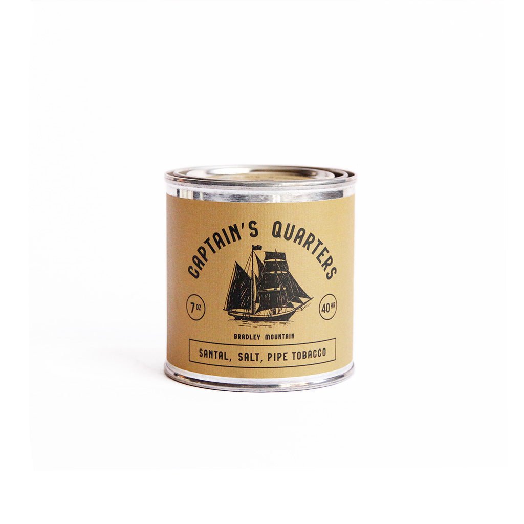 Captain's Quarters candle tin on a white background