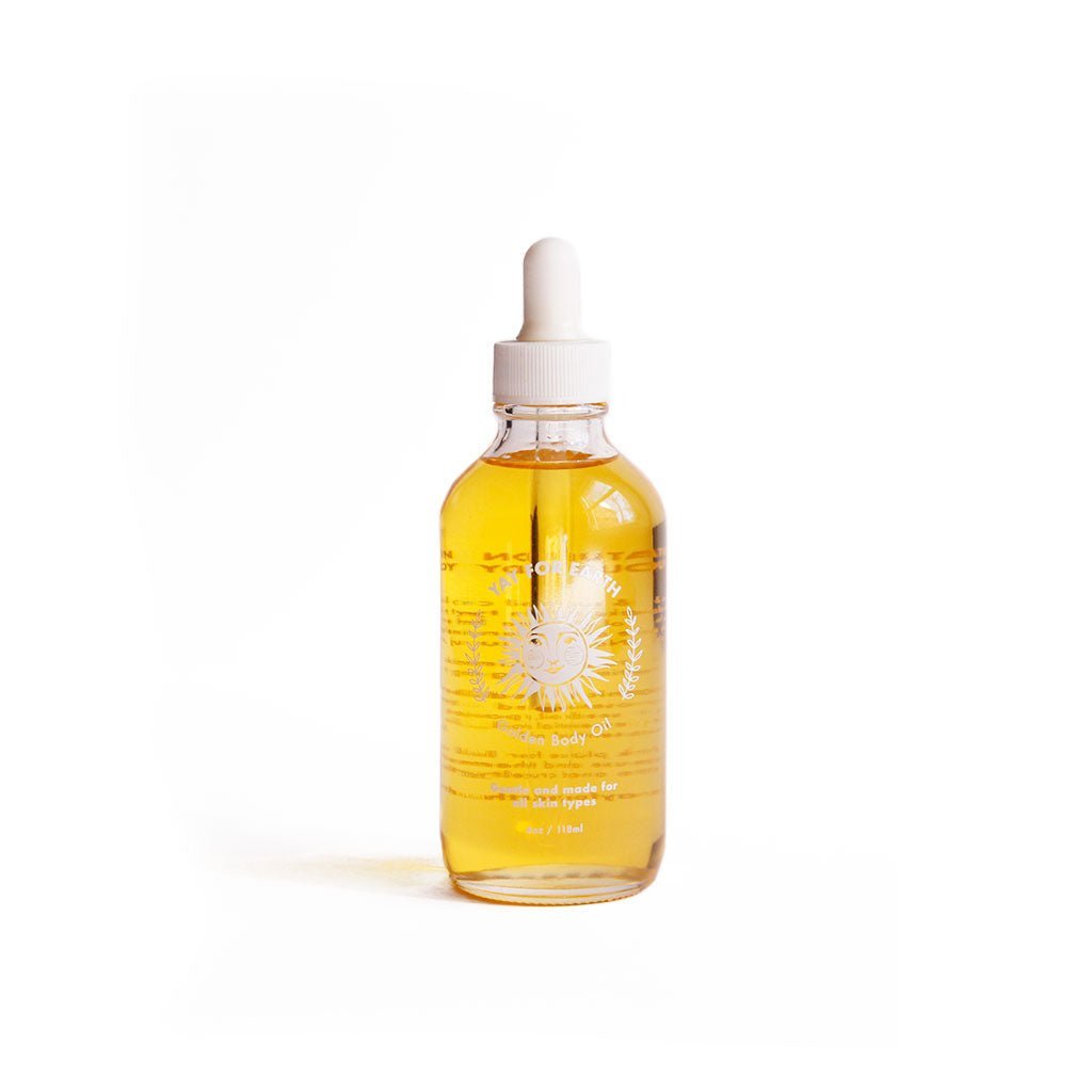 Bottle of Yay for Earth golden body oil with pipette dropper in glass bottle on white background