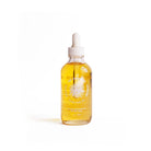 Bottle of Yay for Earth golden body oil with pipette dropper in glass bottle on white background