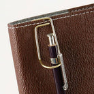 Brown leather wallet with a pen holder attached on a white background